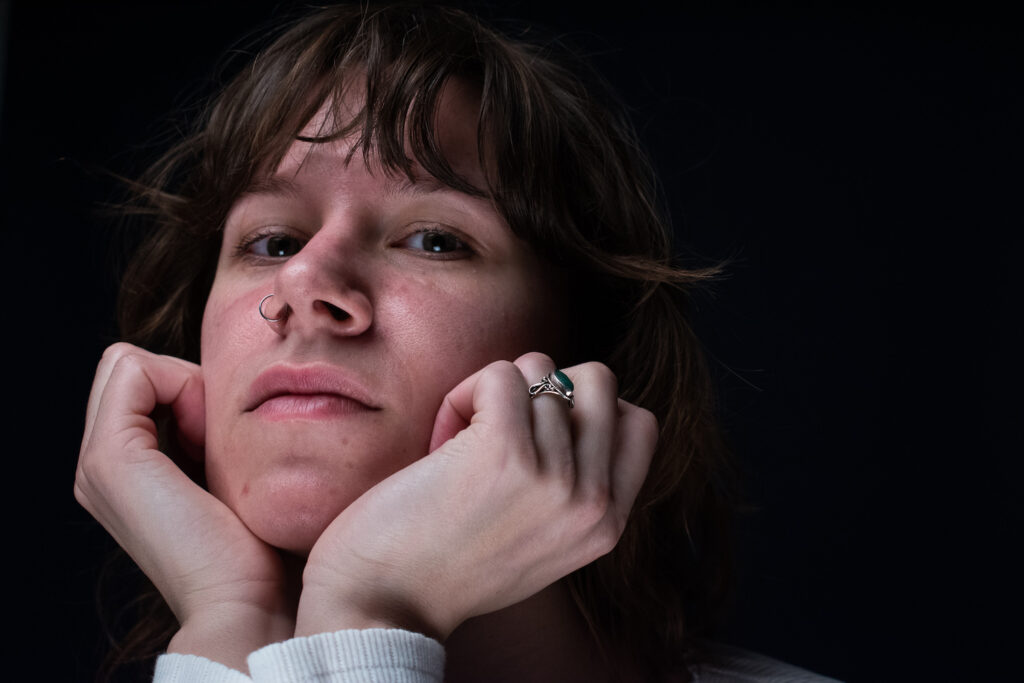 Woman with a white long-sleeve shirt beautifully moving her hands.