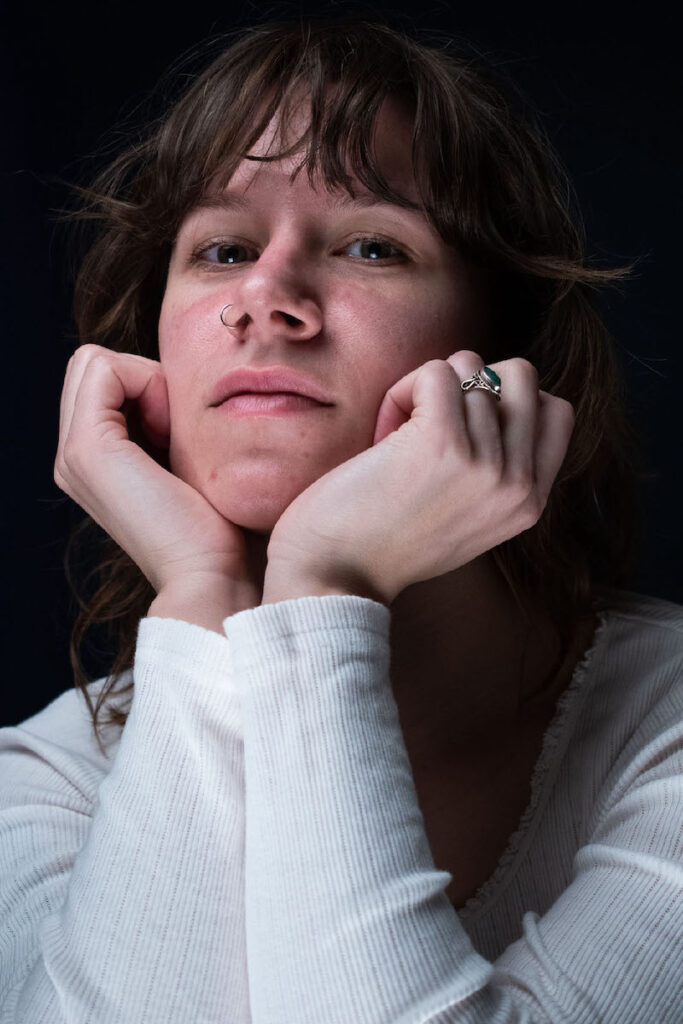 Woman with a white long-sleeve shirt beautifully moving her hands.