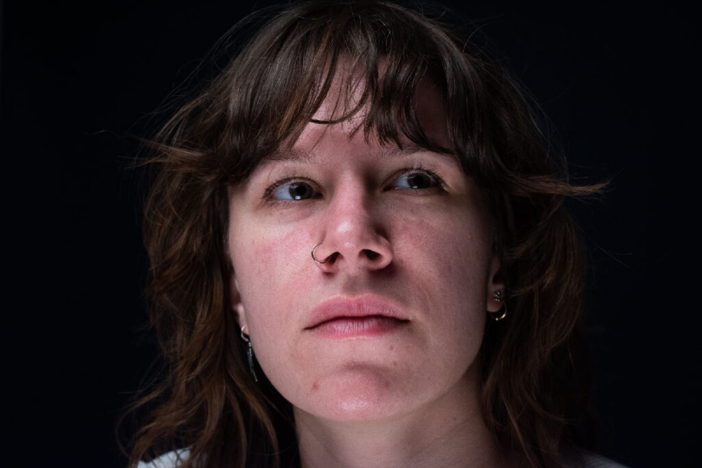 Woman with a white long-sleeve shirt beautifully staring upwards.