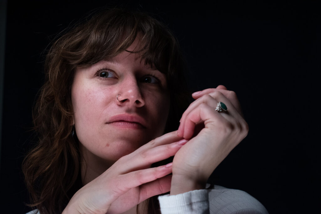 Woman with a white long-sleeve shirt beautifully moving her hands.